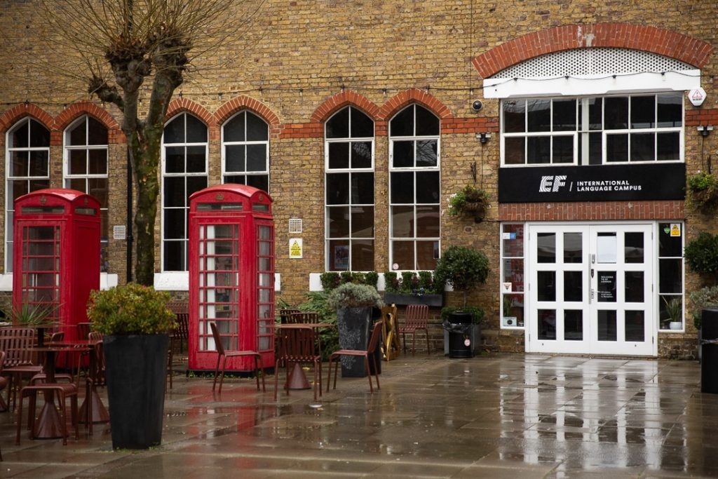 Cours du campus de EF Londres avec des cabines téléphoniques rouge typiques