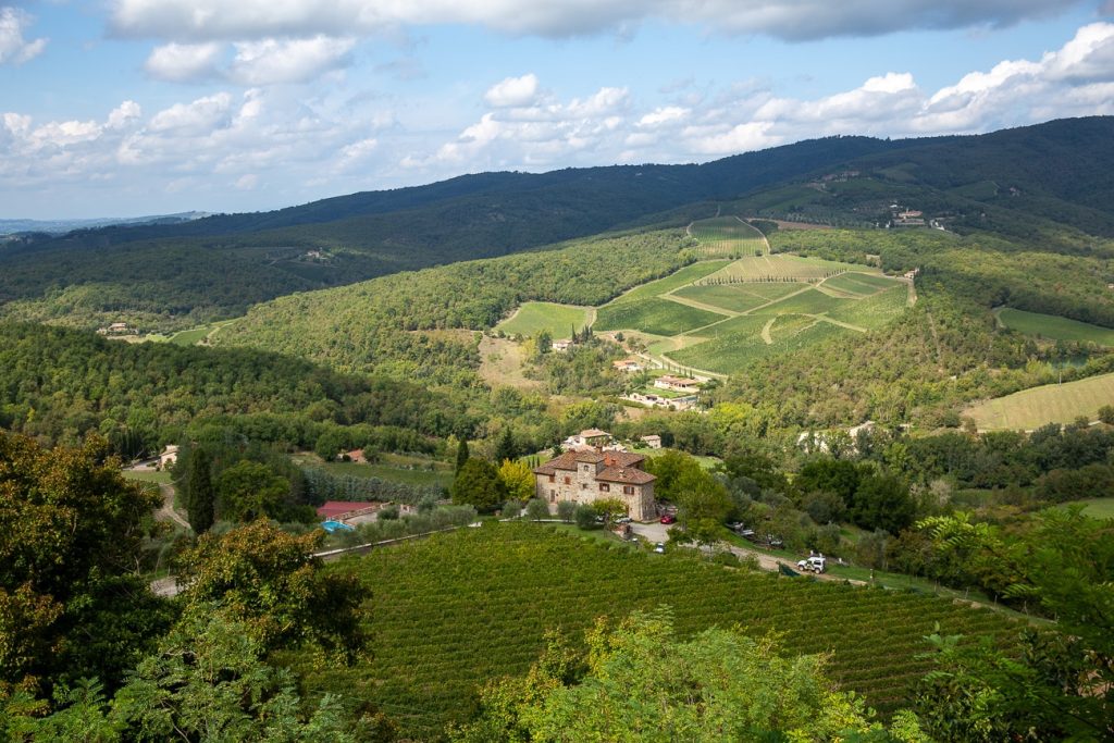 ferme isolée dans les collines de la vallée du chianti, entourée de vignes et de champs d'oliviers